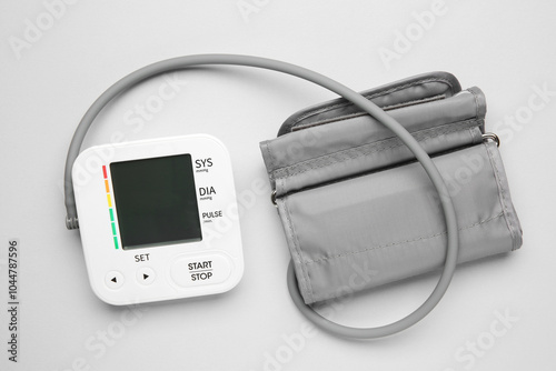 Blood pressure measuring device on light grey background, top view