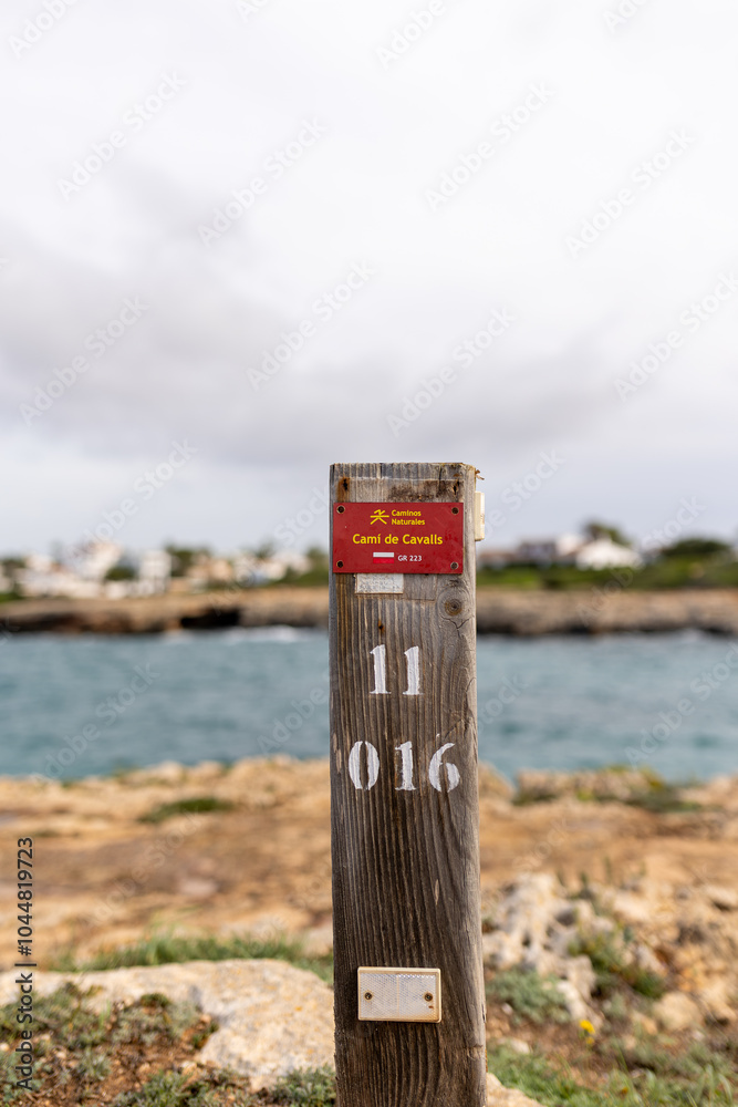 Wooden Signs on the coastal promenade Cami de Cavalls on the island of Menorca, which translated into English the sign says horse trail Wooden Signs on the coastal promenade Cami de Cavalls on the island of Menorca, which translated into English the sign says horse trail