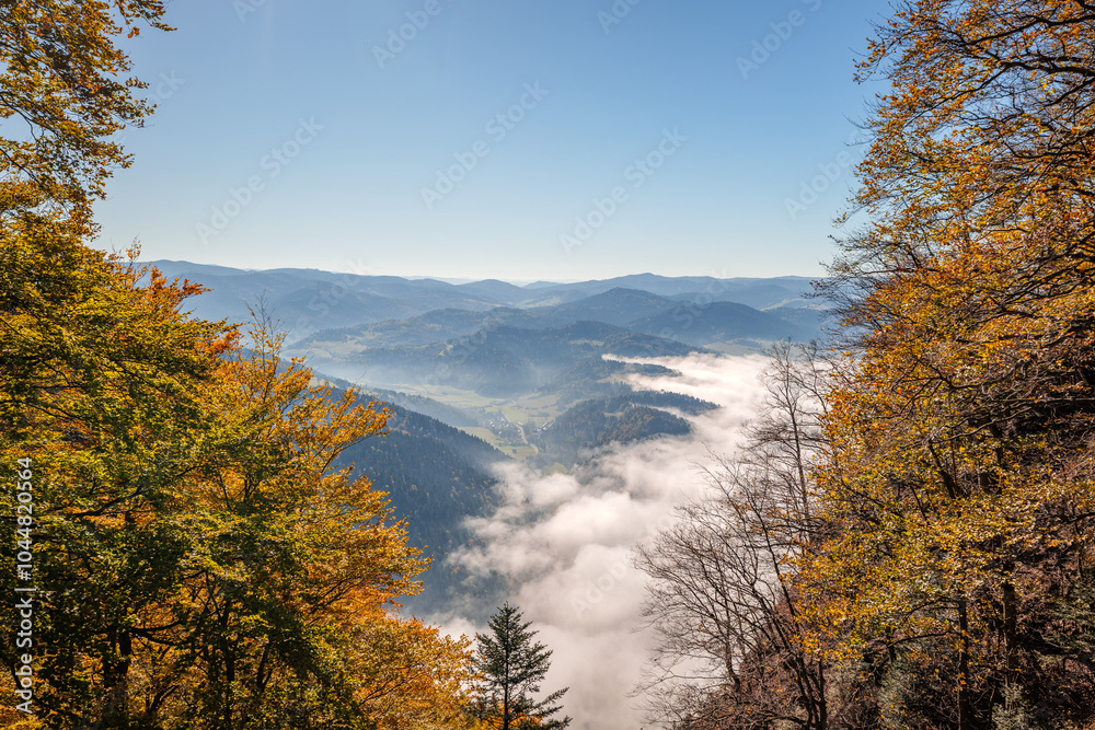 Beautiful autumn mountain landscape framed by colorful autumn trees. Pieniny Mountains. View from the trail to the Trzy Korony peak. Sromowce Nizne, Poland