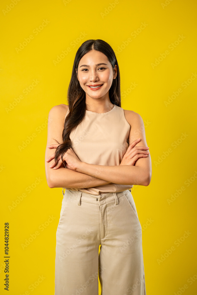 Portrait of Asian beautiful woman standing in isolated yellow background. Portrait of Asian beautiful woman standing in isolated yellow background.