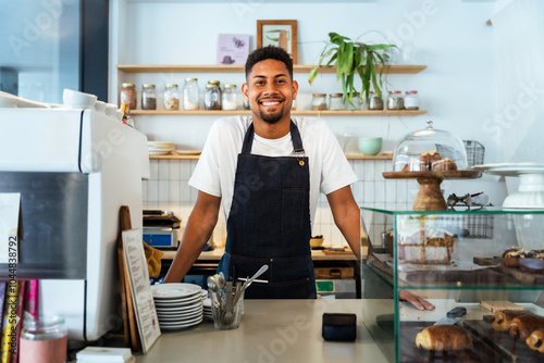 Fotografie Bakery, happy portrait of hispanic black man in cafe ready for serving pastry, coffee and baked foods