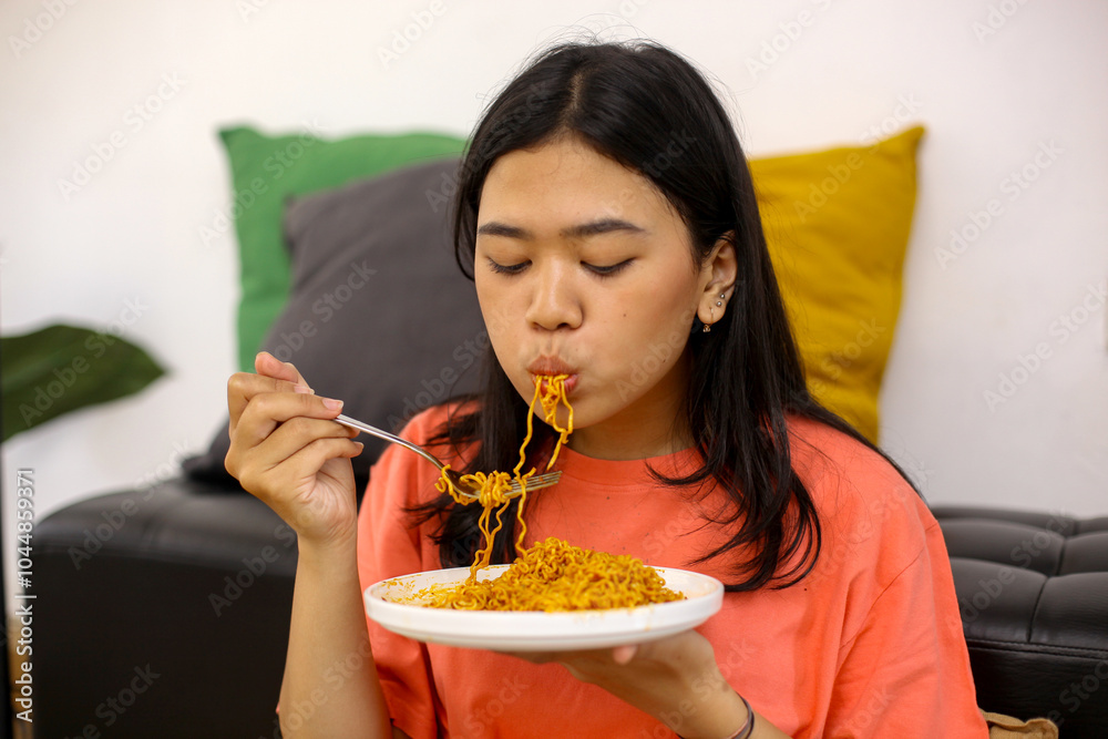 Young Asian Woman Enjoying Eating Noodles At Home Young Asian Woman Enjoying Eating Noodles At Home