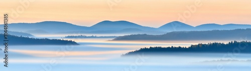 Misty hills and forest layers captured during sunrise, creating a calm and serene atmosphere with blue and peach tones.