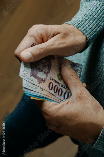 man counting some hungarian forint notes photo