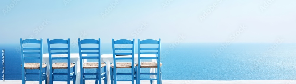 Row of blue chairs overlooking a serene ocean, perfect for relaxation and escape to a tranquil seaside setting. Row of blue chairs overlooking a serene ocean, perfect for relaxation and escape to a tranquil seaside setting.