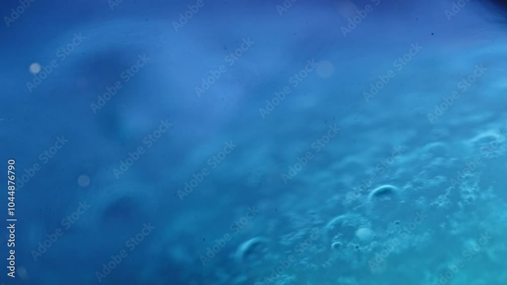 Colorful liquids mixing and blending in a vibrant macro shot with bubbles and soft lighting Colorful liquids mixing and blending in a vibrant macro shot with bubbles and soft lighting