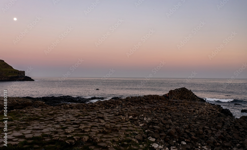 Giant's Causeway at sunset with the full moon in view Giant's Causeway at sunset with the full moon in view