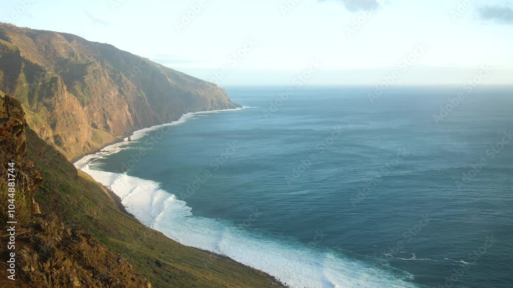 Coastline of madeira beautiful, powerful ocean waves crashing against rocky cliffs, creating white foam against the deep blue sea, aerial view rugged coastline and the raw, untamed beauty of nature Coastline of madeira beautiful, powerful ocean waves crashing against rocky cliffs, creating white foam against the deep blue sea, aerial view rugged coastline and the raw, untamed beauty of nature