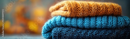 Knitted sweaters stacked on top of each other photo