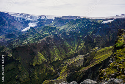 Epic view to icelandic volcanic landscape with the deep valley hills, mountains and glacier when hiking in the Icelandic nature evokes harsh nordic condition, virgin fragile nature and free spirit photo