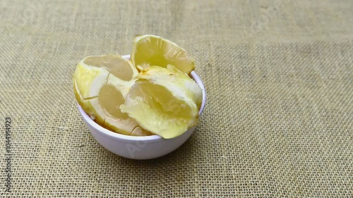 Ice Apple or Palmyra Palm Fruit in White Bowl Isolated on Burlap Fabric with Copy Space, Also Known as Toddy Palm, Tala or Doub Palm photo