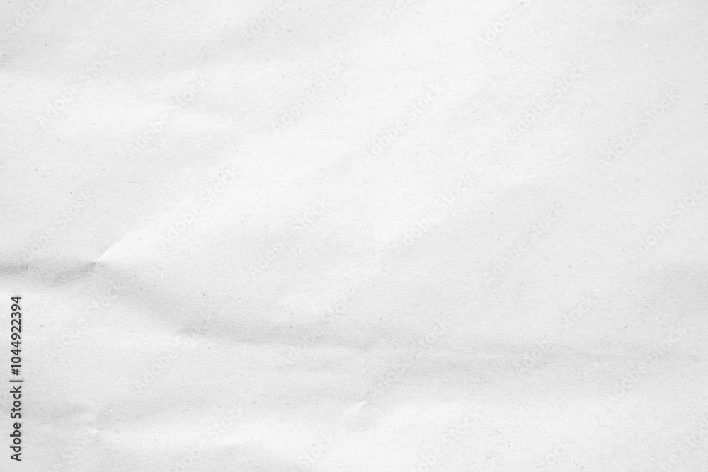 Obraz premium Crumpled white paper texture with a soft, wintery feel, perfect for backgrounds and design.