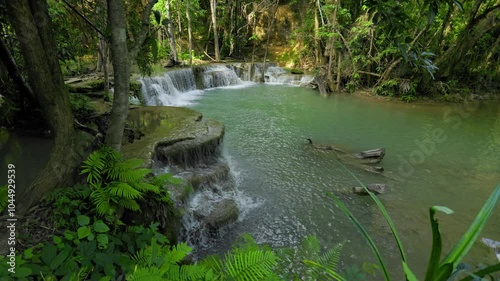 Huai Mae Khamin Waterfall is located in Kanchanaburi Province, Thailand. It is a beautiful waterfall with cool and refreshing water temperatures. It is located in a lush forest with large green trees. photo