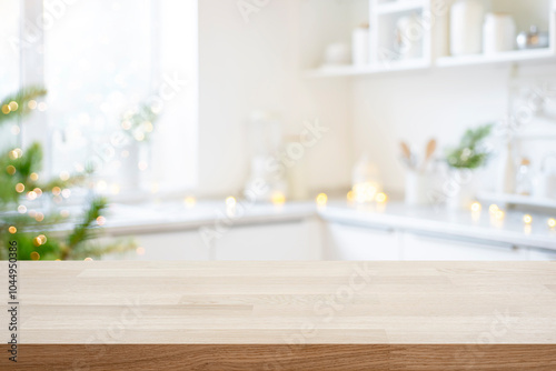 Empty wooden table ready for product montage on background of decorated Christmas kitchen background