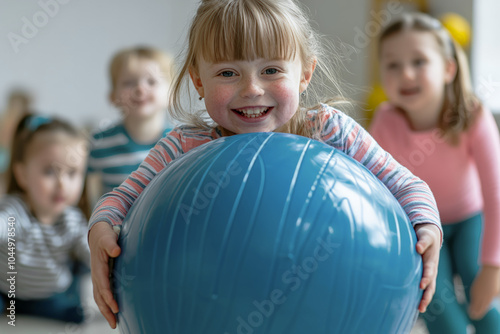 a group of children with Down syndrome participating in adapted physical exercises, holding a large blue ball, indoor playroom photo