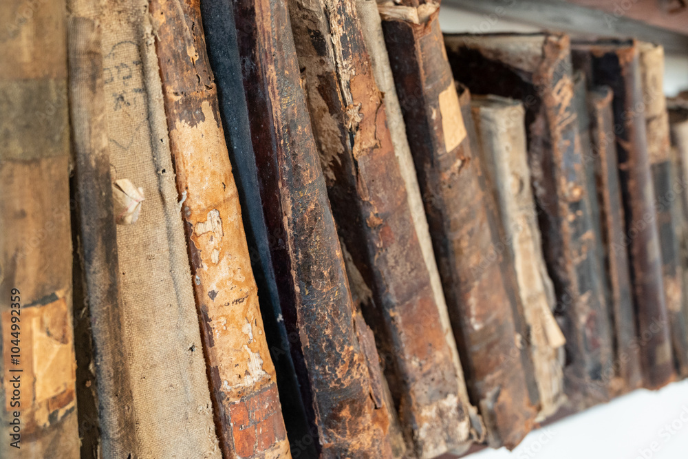 collection of old weathered books with torn backs and loose pages collection of old weathered books with torn backs and loose pages