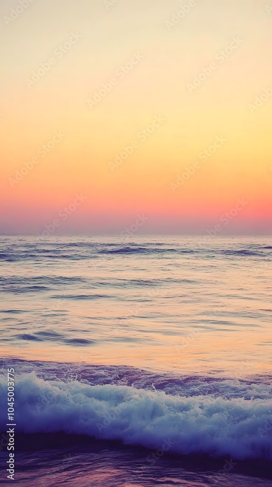 Fototapeta premium A calm sea at sunset, with the horizon blending into a gradient of purples and oranges, creates an atmosphere that feels serene and peaceful.