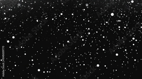 Snowflakes gently falling through the dark night sky creating a serene winter atmosphere