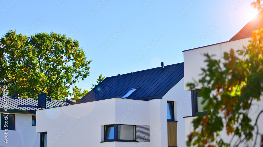 Harmony with nature, eco architecture. Terraced single family homes in newly developed housing estate. The real estate market in the suburbs with lush greenery surrounding. Harmony with nature, eco architecture. Terraced single family homes in newly developed housing estate. The real estate market in the suburbs with lush greenery surrounding.