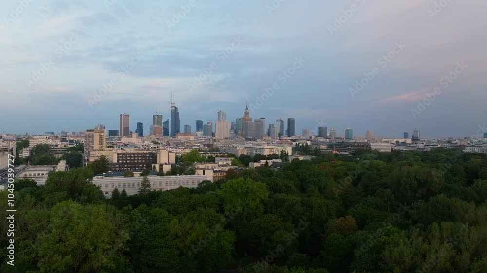 Warsaw's skyline rises majestically above a lush green forest, bathed in the soft light of early morning. The scene captures a harmonious blend of urban and natural beauty Warsaw's skyline rises majestically above a lush green forest, bathed in the soft light of early morning. The scene captures a harmonious blend of urban and natural beauty
