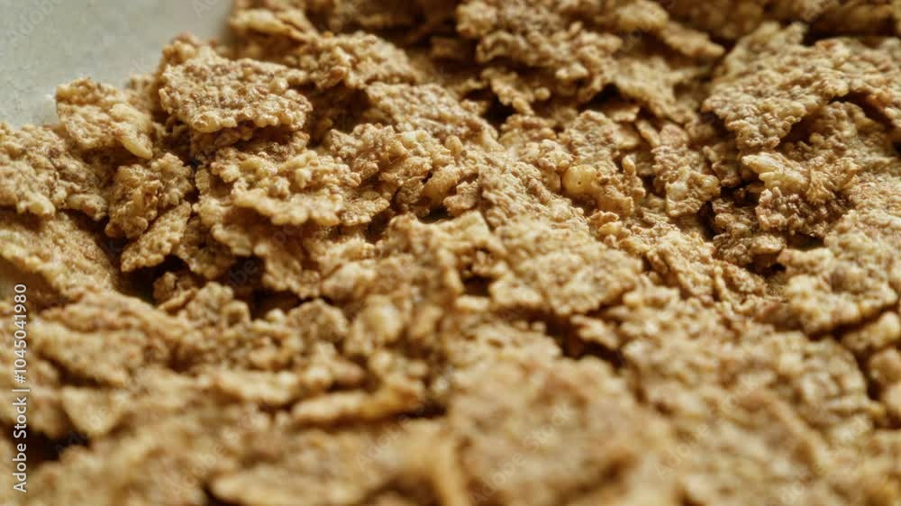 Closeup of crunchy cornflakes cereal perfect for breakfast, highlighting the textured and crispy pieces as they lie clustered together, ideal for food and breakfast related themes. Closeup of crunchy cornflakes cereal perfect for breakfast, highlighting the textured and crispy pieces as they lie clustered together, ideal for food and breakfast related themes.