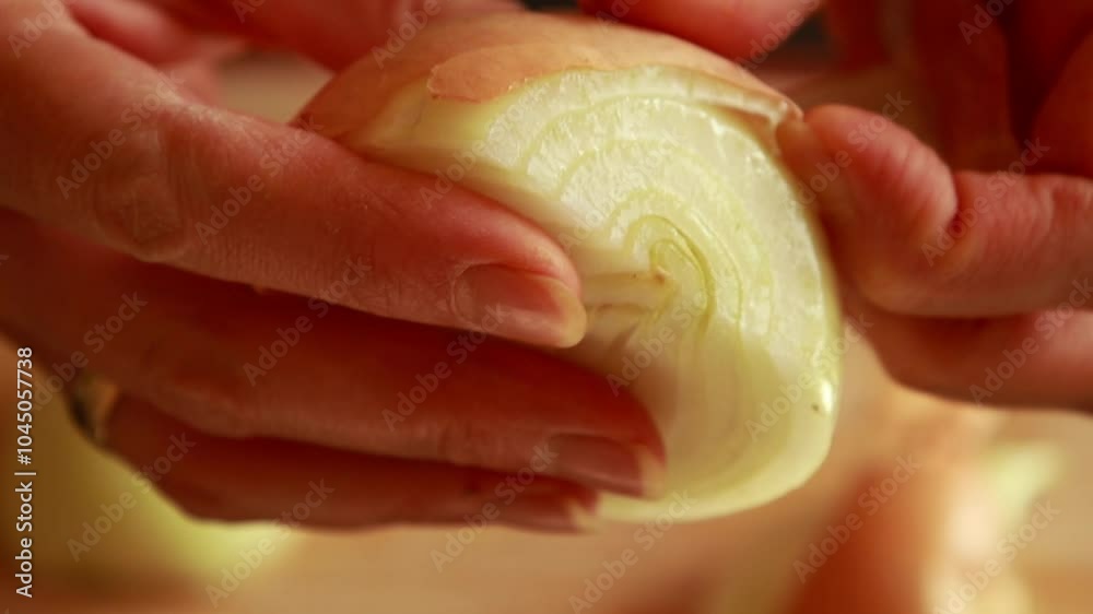 woman's hands skillfully peeling a yellow onion woman's hands skillfully peeling a yellow onion