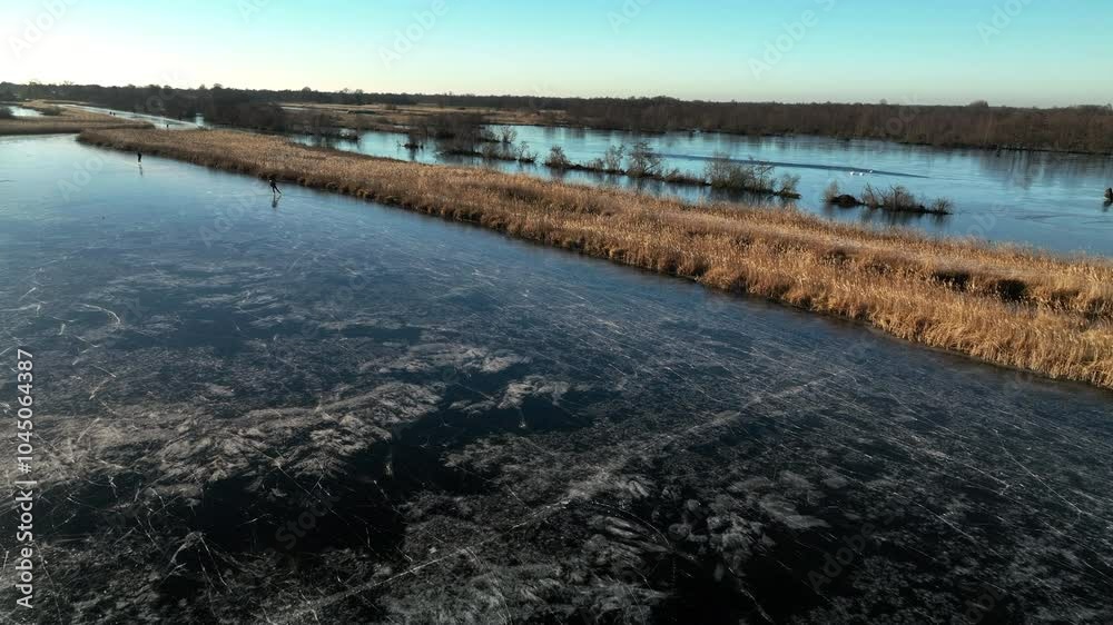 custom made wallpaper toronto digitalIce skating on a frozen lake in the Weerribben Wieden nature reserve during a cold winter day in The Netherlands.