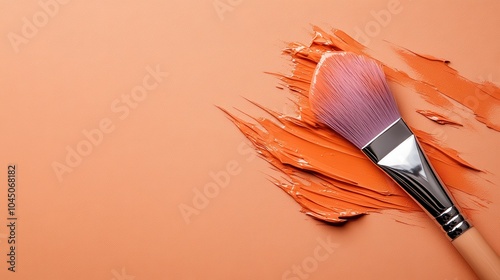 A single brush masterfully spreads orange paint on a textured surface, signifying the artistic skill and creativity involved in bringing imaginative ideas to life. photo