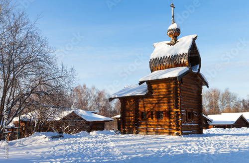 Irkutsk. Famous museum of old Russian wooden architecture Taltsy is place of attraction for tourists on sunny winter day. View of beautiful wooden Kazan Church 1679 photo