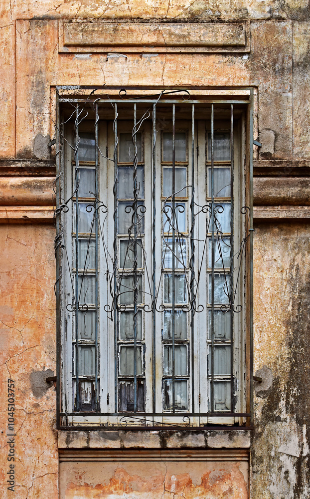 Old window with grid on old facade in Ribeirao Preto, Sao Paulo, Brazil
