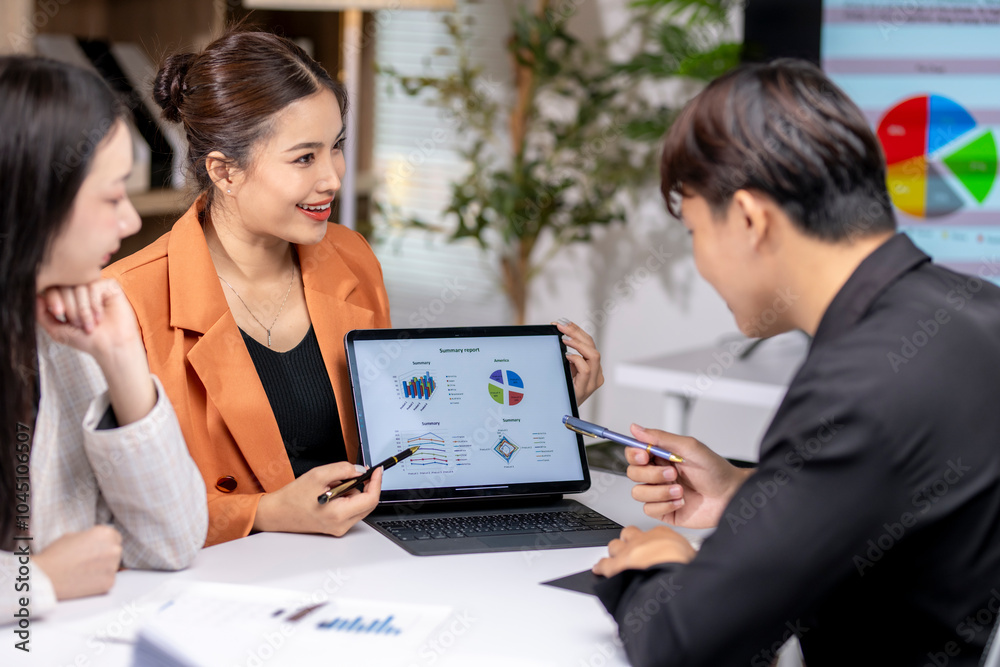 Business team analyzing financial data on digital tablet in modern office Business team analyzing financial data on digital tablet in modern office