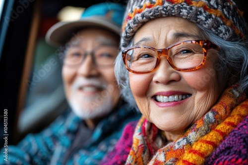 An elderly couple, clad in warm hats and glasses, smiling contentedly while enjoying a scenic outdoor setting, highlighting themes of nature, happiness, and togetherness.