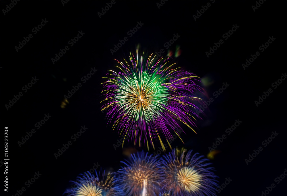 An isolated firework display against a dark background, featuring vibrant green, yellow, and purple hues, with smaller bursts of blue and white fireworks in the foreground. An isolated firework display against a dark background, featuring vibrant green, yellow, and purple hues, with smaller bursts of blue and white fireworks in the foreground.