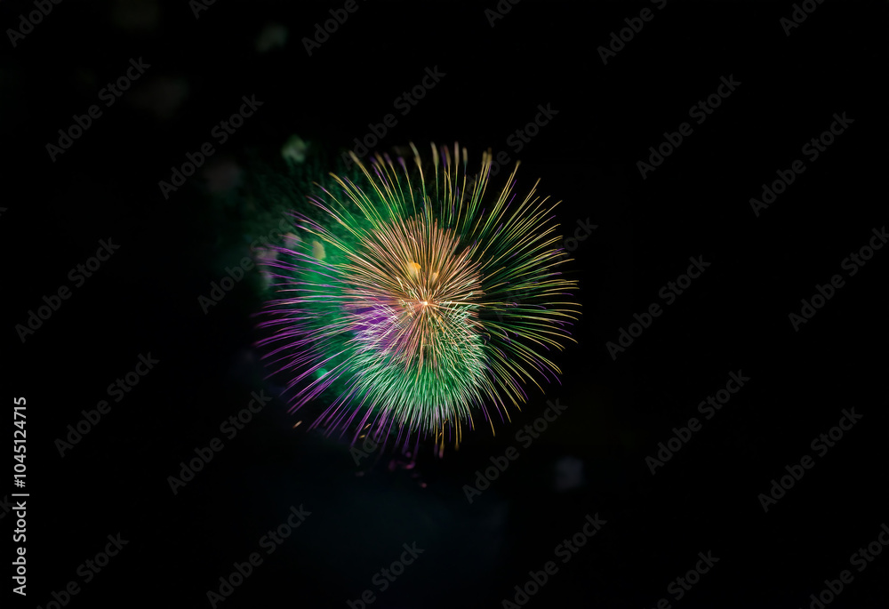An isolated firework display against a black background with vibrant green, purple, and gold bursts. An isolated firework display against a black background with vibrant green, purple, and gold bursts.