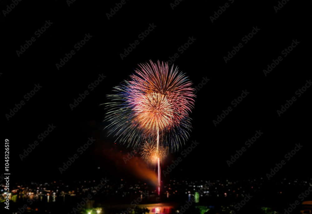 A single, vibrant firework display explodes against a dark, isolated background. A single, vibrant firework display explodes against a dark, isolated background.