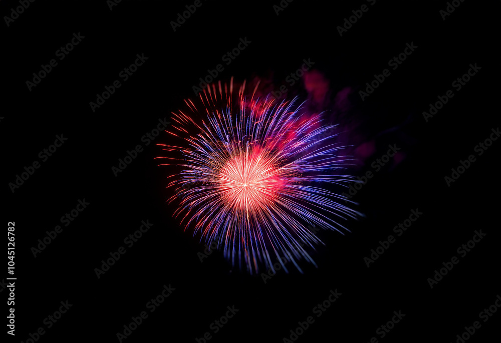 A single firework bursts in a vibrant display of red, blue, and pink against a black background. A single firework bursts in a vibrant display of red, blue, and pink against a black background.