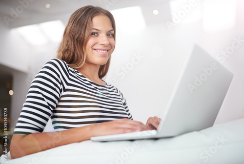 Laptop, typing and portrait of happy woman on sofa for freelancing, reading blog or relax in home. Smile, face and computer for hybrid work, research and language translation for social media in UK