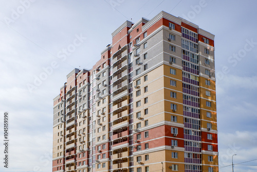 A tall building with red, yellow, and white colors