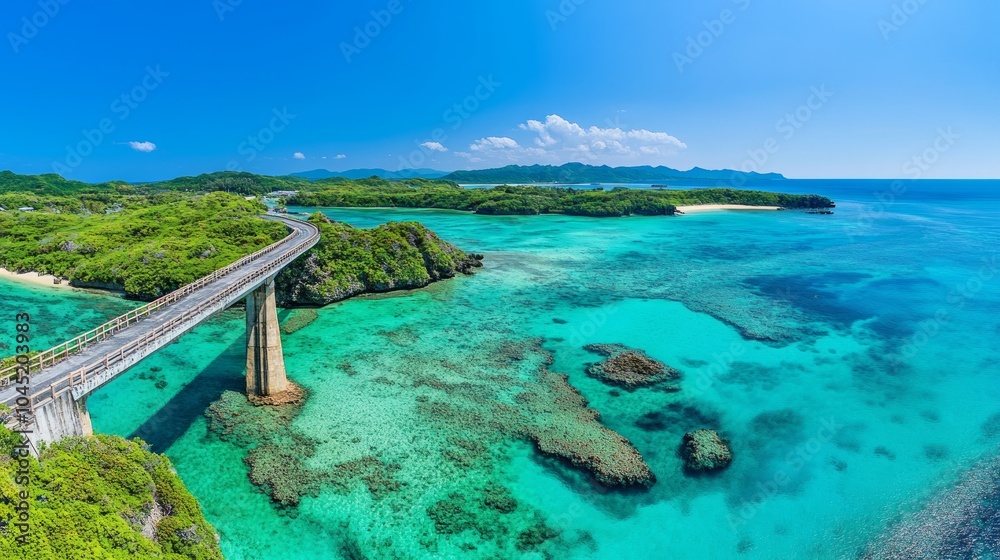A panoramic view of a bridge connecting two islands with a turquoise blue ocean and clear water. A panoramic view of a bridge connecting two islands with a turquoise blue ocean and clear water.