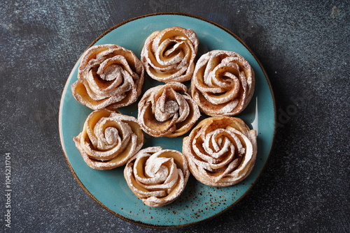 Rose shape apple pastry with cinnamon and shugar powder photo