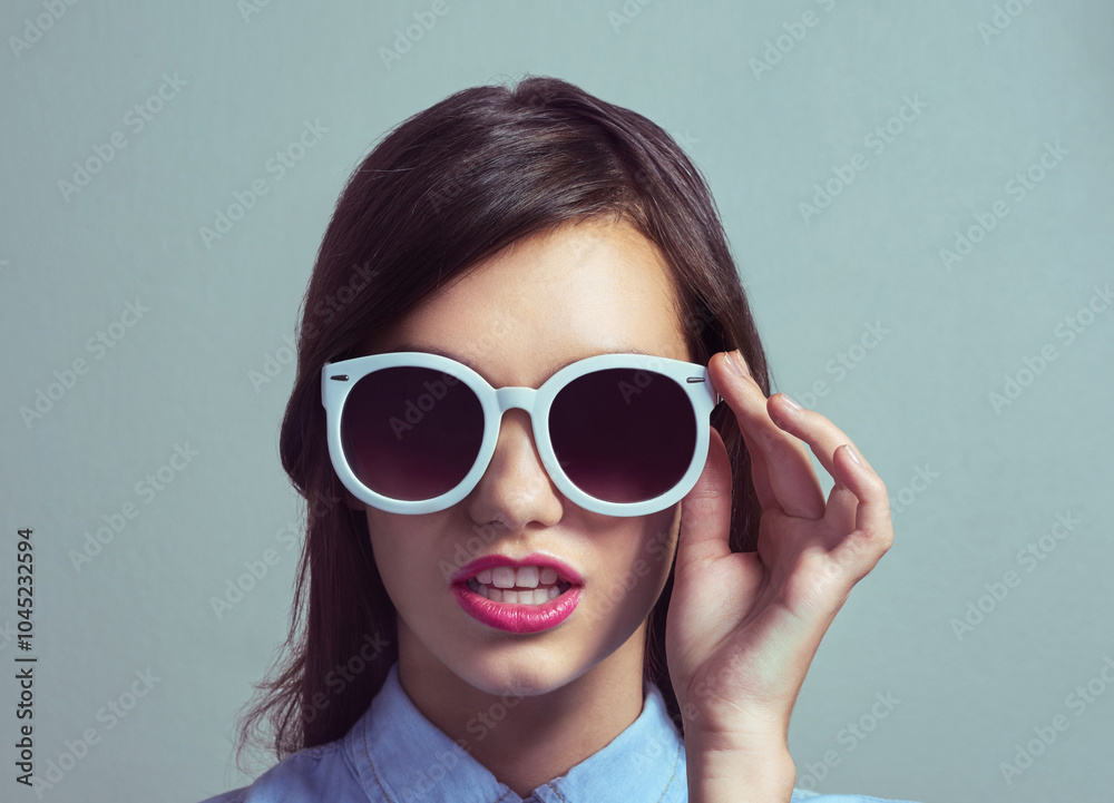 Studio, woman and chic with sunglasses for fashion, trendy style and edgy with hand for confidence. Female person, model or lipstick with accessory for beauty, magazine publication or gray background Studio, woman and chic with sunglasses for fashion, trendy style and edgy with hand for confidence. Female person, model or lipstick with accessory for beauty, magazine publication or gray background
