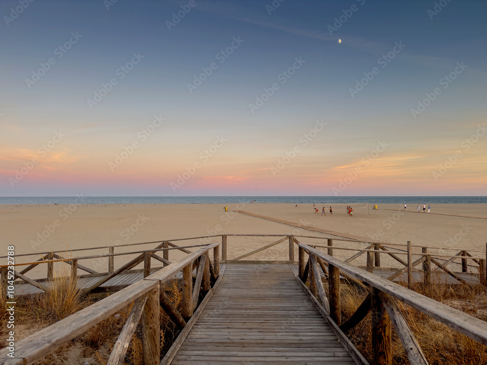 Arrival view of the beach with sunset. With wooden jetty. Arrival view of the beach with sunset. With wooden jetty.