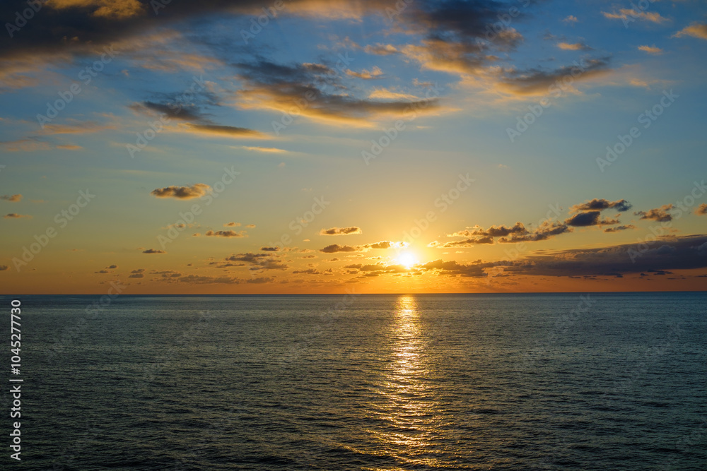 Romantic colorful sunset at the sea. View of Beautiful glorious golden sunset and golden hour above the sea in evening. Romantic colorful sunset at the sea. View of Beautiful glorious golden sunset and golden hour above the sea in evening.