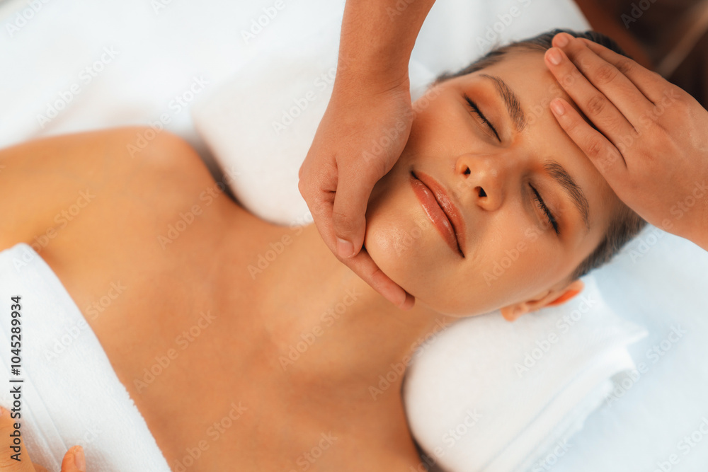 Panorama top view of woman enjoying relaxing anti-stress head massage and pampering facial beauty skin recreation leisure in dayspa modern light ambient at luxury resort or hotel spa salon. Quiescent Panorama top view of woman enjoying relaxing anti-stress head massage and pampering facial beauty skin recreation leisure in dayspa modern light ambient at luxury resort or hotel spa salon. Quiescent