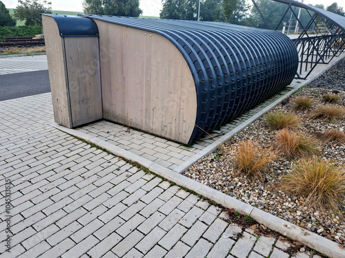 bike storage with lock boxes at the station. for a small coin you can park your bike for the whole day. motorcycle. train station, gray photo