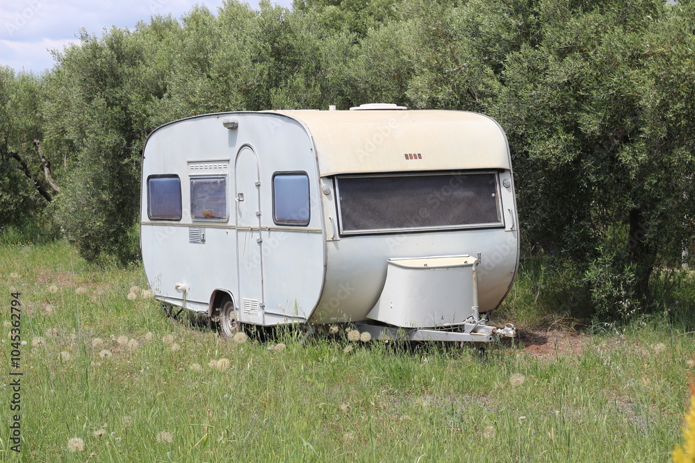 Caravan Parked in a Garden Surrounded by Olive Trees Caravan Parked in a Garden Surrounded by Olive Trees