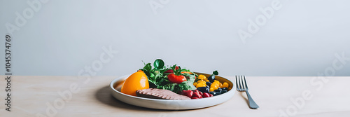 A plate of colorful salad with a fork on a wooden table  perfect for a healthy meal   