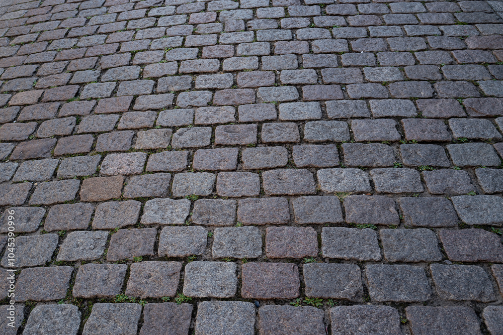 Pavement road. Stone cladding. Rough brick road. Cobblestone pavement background. Textured background. Sidewalk. Road. Old cobblestone road. Pavement road. Stone cladding. Rough brick road. Cobblestone pavement background. Textured background. Sidewalk. Road. Old cobblestone road.