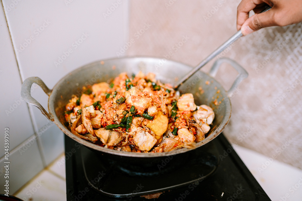 A pan-cooked dish featuring tofu, eggs, chilies, and vegetables. A pan-cooked dish featuring tofu, eggs, chilies, and vegetables.