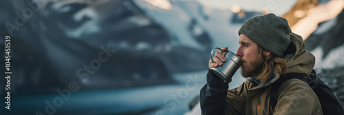 Portrait of a climber resting and drink tea with mountain in the background. Man drinking coffee at a mountaineering camp. photo